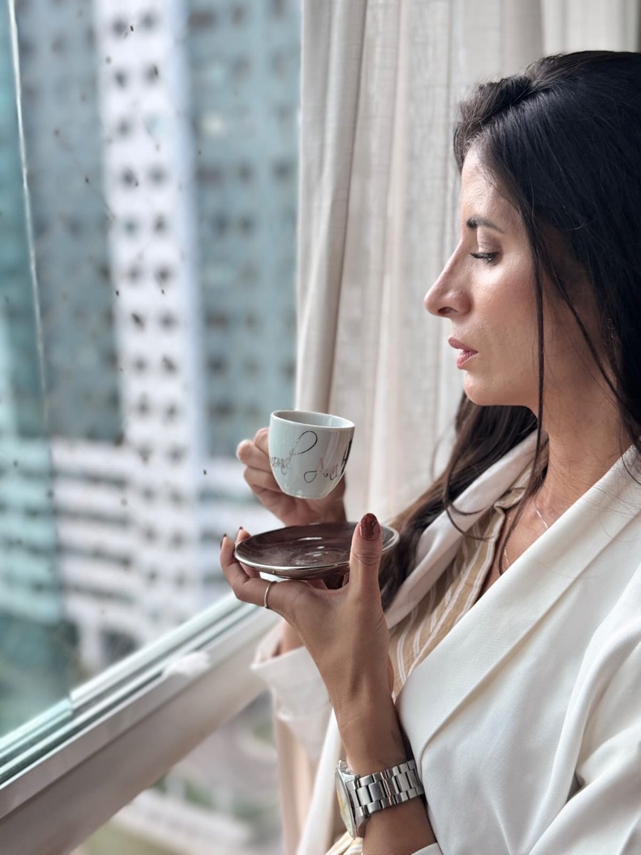 Marianna Crispim, psicóloga clínica, junto à janela com uma taça de café